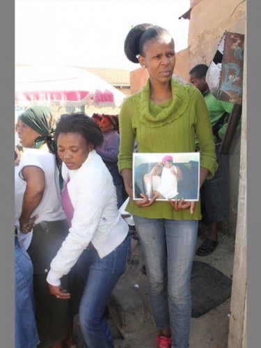 Siyasanga Dywati, holds a picture of her late friend Aphiwe Zweni. 