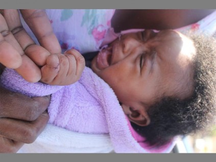 Three months old Ntsoaki Mboweni cries in pain from rat bites to her fingers