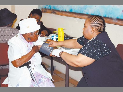 DIS-CHEM clinic sister Thandiwe Mngoma tests the blood sugar of Margaret Sithole at the Phuthaditjaba Centre.