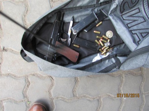 A firearm and ammunition found in possession of two suspects.