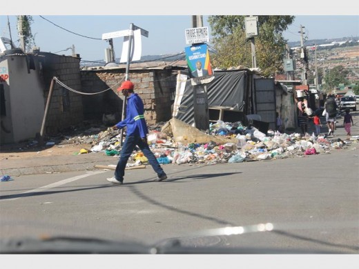 The spot behind the washing line is where a man died in a burnt-out caravan.