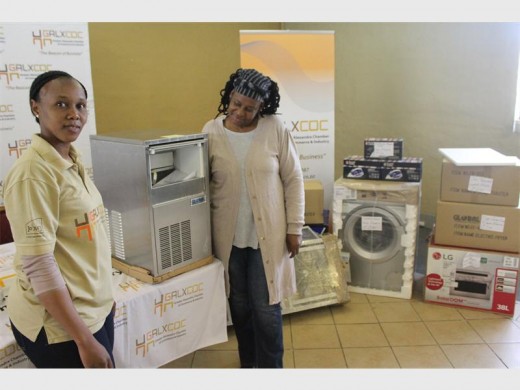 Greater Alex Chamber of Commerce and Industry's Nomakhaya Mahlaule and Nickie Medupe admore her new ice-making machine.
