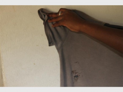 A hole surrounded by blood stains on the victim's T-shirt after being stabbed with a pair of scissors.