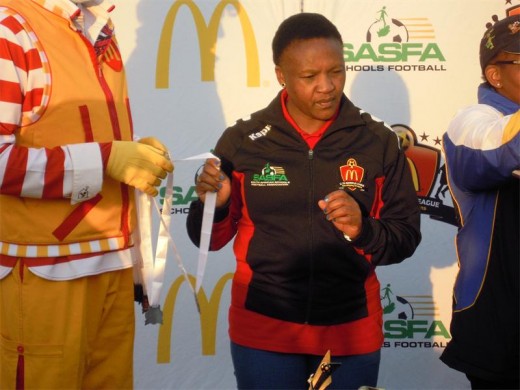 ALEX schools sports committee official and Dr Knak Primary School teacher, Mamikie Mosethe hands out medals at the Alabama Stadium in Klerksdorp in the North West – Gauteng festival.