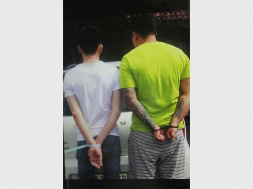 The two suspects are cuffed.