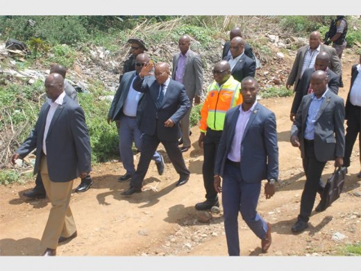 President Jacob Zuma (waving) and his security entourage visit the Jukskei River flood victims. Next to him in the bright jacket is Premier David Makhura.