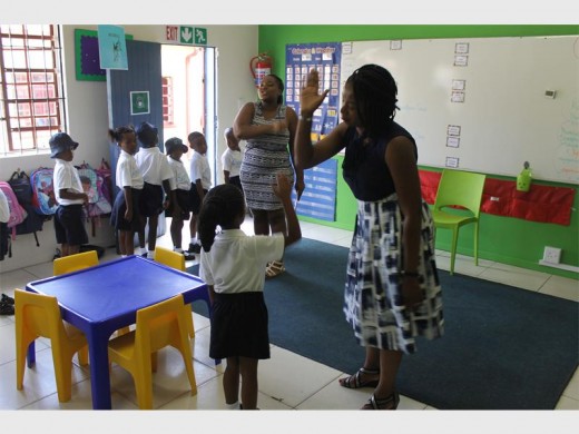 Kgololo Academy founder Waahida Tolbert-Mbatha shares a high five.