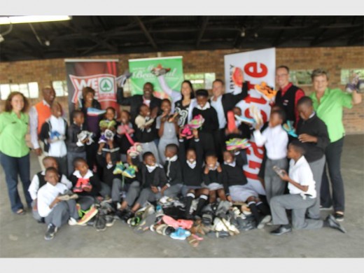 Skeen Primary School youngsters receive a donation of running shoes from Spar and Caxton's Rosebank Killarney Gazette.