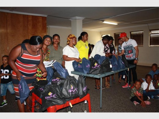 Caregivers from Ratang Bana and church members from Elev8 Ministries get ready to handover the shoes to the children.