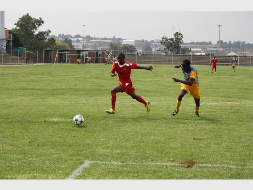 Gauteng FC's Ramotsepa Nthite (red) races off with the ball towards the goals with a Soweto Panthers player in hot pursuit.